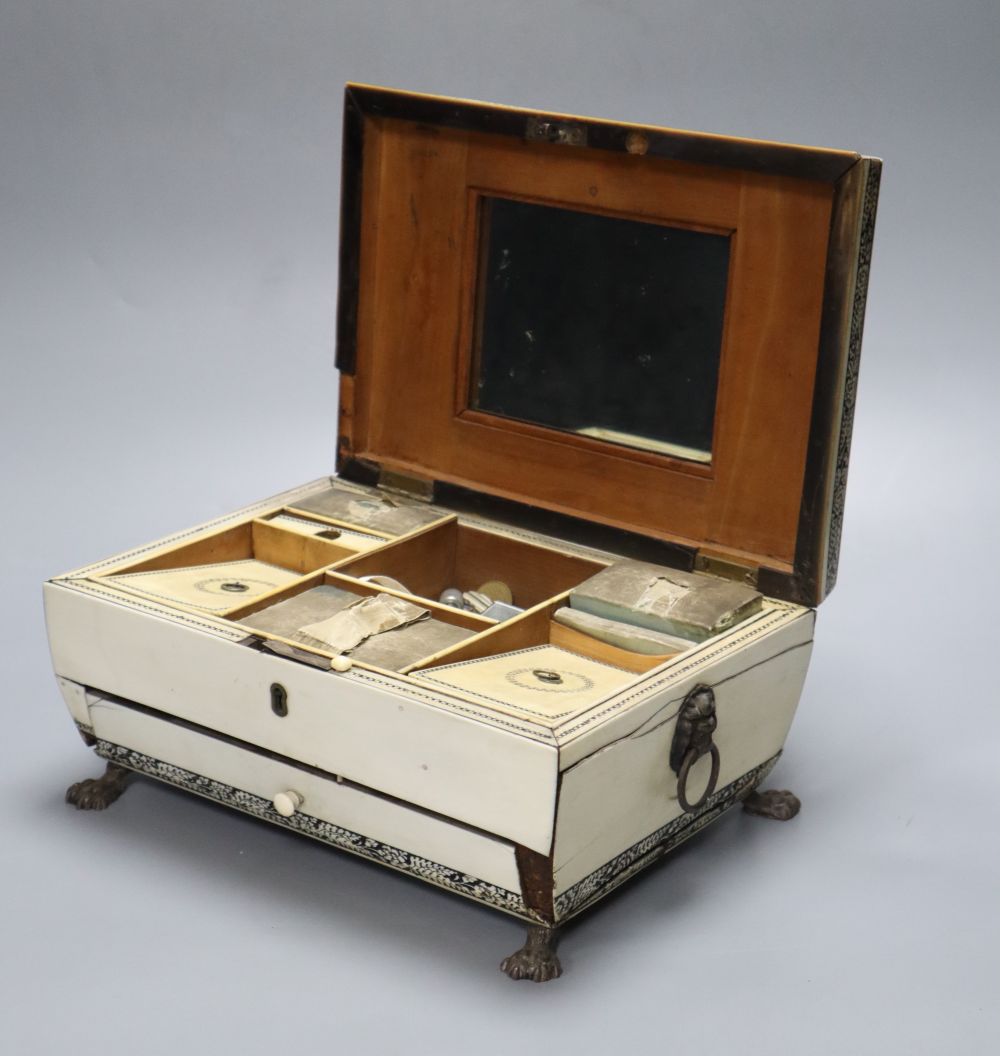 An early 19th century Anglo-Indian Vizagapatam dressing table box, of sarcophagus form, with lion paw feet, width 27cm